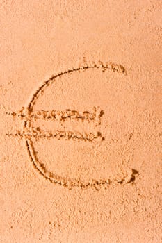 euro currency symbol is drawn on wet sand on the beach