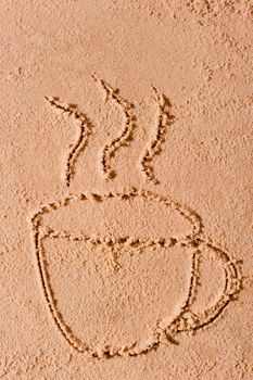 drawing in the sand a hot cup of coffee