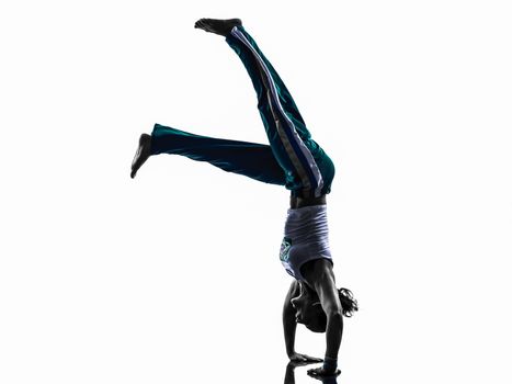 one caucasian woman capoeira dancer dancing in silhouette studio isolated on white background