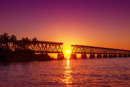Colorful sunset or sunrise with broken bridge