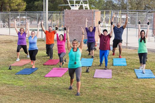 Diverse group of adults working out outdoors