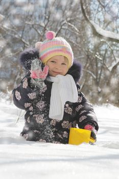 Playful girl having fun in snowy park