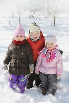 Three happy children having fun in winter