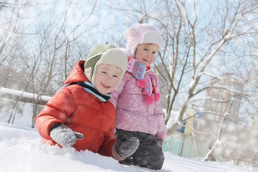 Sister and brother having fun in snow