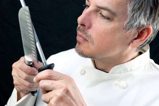 Close-up of a chef sharpening his knife.