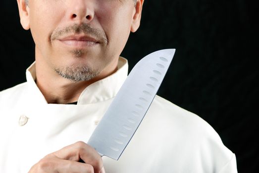 Close-up of a chef displaying his knife.