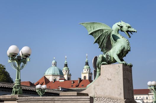 Dragon Bridge with St Nicholas Cathedral in the background, in Ljubljana, Slovenia.