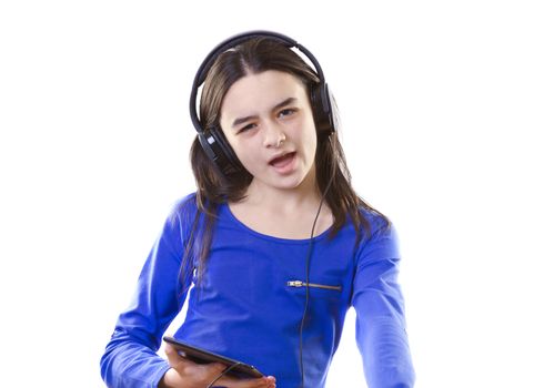 Smiling girl listening to music, holding a tablet pc in hands