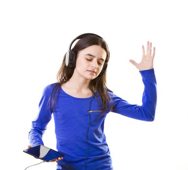 Smiling girl listening to music, holding a tablet pc in hands