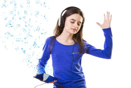 Smiling girl listening to music, holding a tablet pc in hands