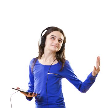 Smiling girl listening to music, holding a tablet pc in hands