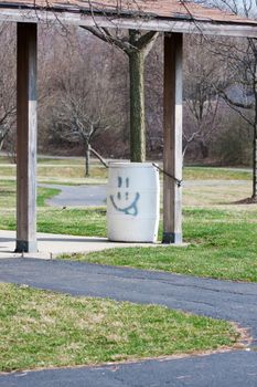Garbage Bin at a park with a smile 