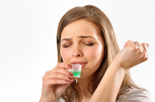 girl taking cough syrup, isolated on white