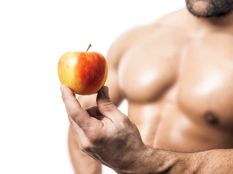 An image of a handsome young muscular sports man and a apple