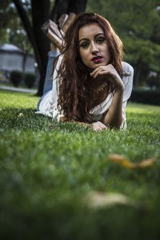 beautiful girl lays on a grass