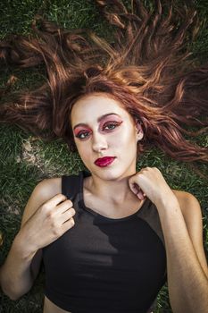 beautiful girl lays on a grass