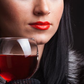 Red lips and glass of wine close up