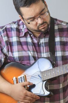 Overweight man playing the guitar