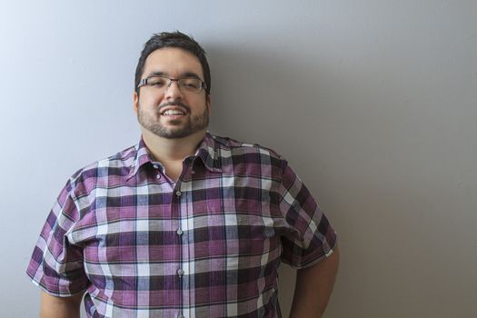 Young man in his late twenties relaxing on a wall