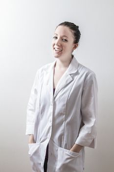 woman in her twenty with big smile, wearing a lab coat
