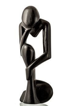 A wooden figure of a thinking man made by west african craftsmen