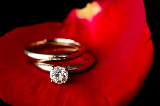 The perfect Valentine's Day gift, an engagement ring on a red rose