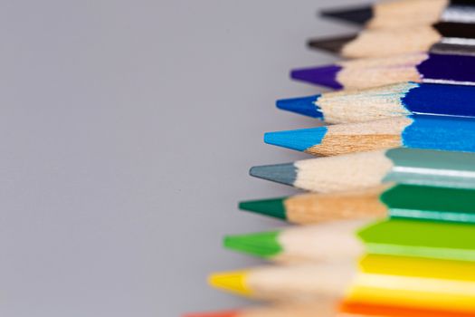 Brightly colored wooden pencils closeup shot background