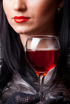 Red lips and glass of wine close up