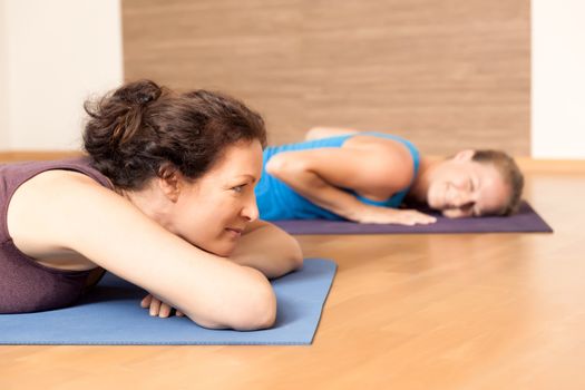 An image of some people relaxing after yoga exercises