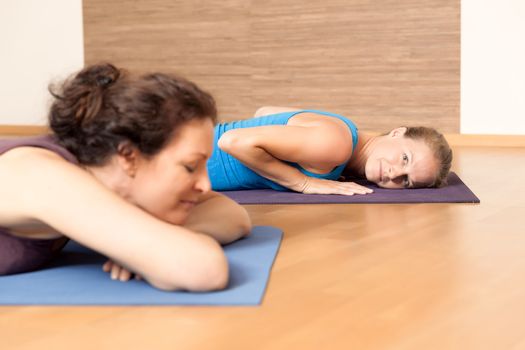 An image of some people relaxing after yoga exercises