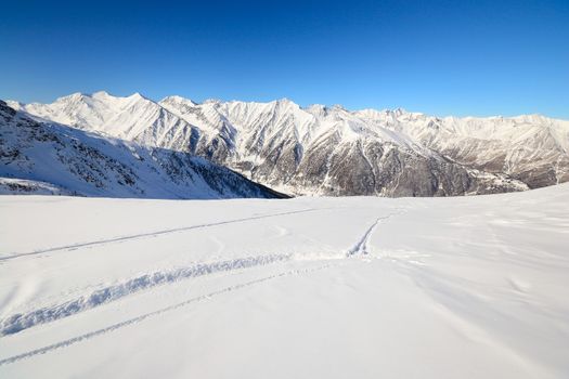 Ski touring tracks (back country ski tracks) in majestic high mountain scenery, italian Alps