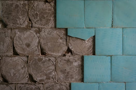 old ceramic floor tiles falling off from the wall