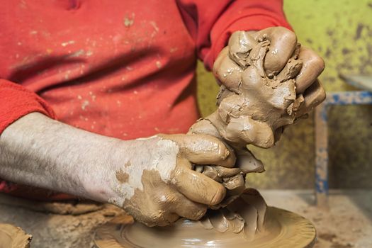 Potter preparing a piece of clay to start working, clay pottery ceramics typical of Bailen, Jaen province, Andalucia, Spain