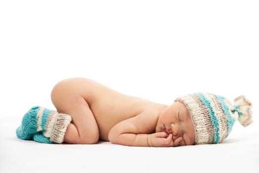 Newborn baby boy asleep over white background