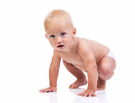 Cute baby boy crouching over white background