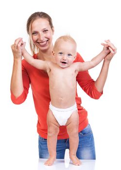 Baby boy learning to walk with mother's help over white