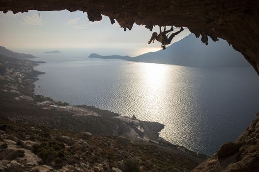 Family rock climber against picturesque view of Telendos Island at sunset. Kalymnos Island, Greece