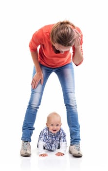 Young Caucasian mother and baby boy playing over white background