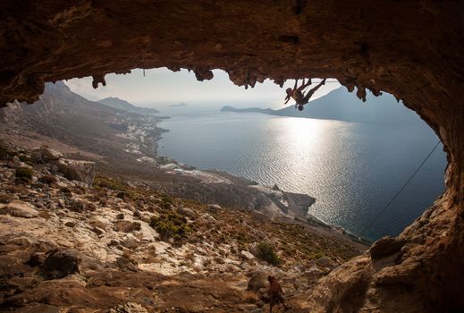 Family rock climber against picturesque view of Telendos Island at sunset. Kalymnos Island, Greece.