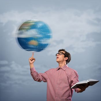 young man with a book thinks. keeps the finger symbol of the planet Earth. NASA images used