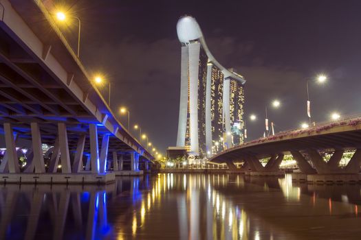 East Coast Parkway on left  and Bayfront avenue on right with Marina Bay Sands hotel by night in Singapore
