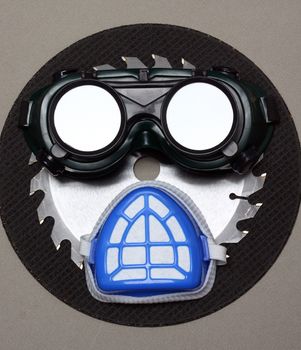 goggles and a mask as a human face. safety concept