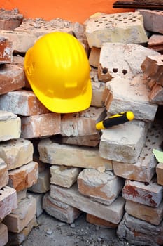 Bricks, trowel and helmet on work place