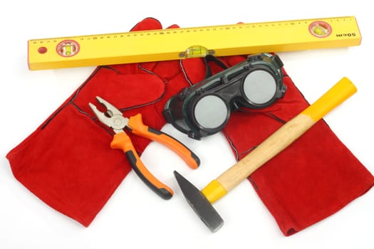 Close up of bunch of hand tools on a white background