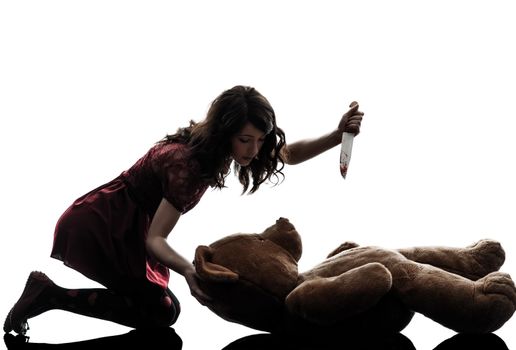 one caucasian strange young woman killing her teddy bear in silhouette white background