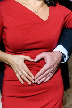 Wedding Couple make heart shape with their hands