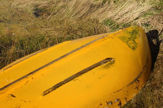 Upturned yellow row boat