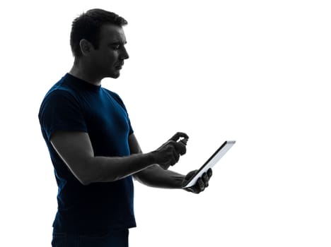one caucasian man cleaning dusting digital tablet  in silhouette on white background