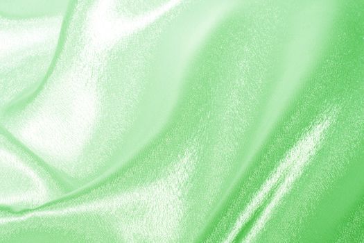 Abstract background green silk fabric with beautiful waves