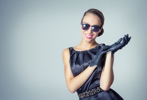 Fashion portrait of beautiful young girl with sunglasses in classic vintage style